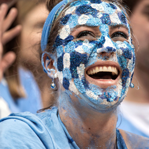 Photo of woman painted up in Carolina blue for game day