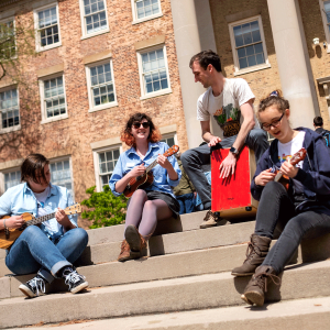Group of ukulele players performing on the steps of South Building