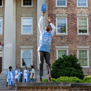 A Carolina senior poses in a number 23 basketball jersey
