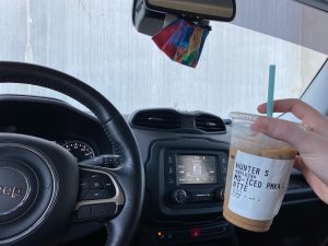 ice coffee being held up inside a car