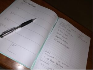 An open planner with a pen on the paper 
