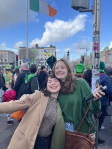 Celeste standing and smiling with a friend on St Patrick's Day in Dublin City Center.